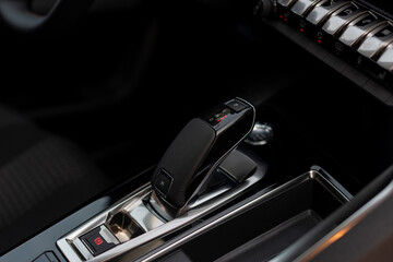 Modern automatic transmission parked inside the interior of a modern vehicle. Soft selective focus.