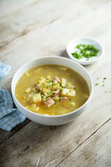 Traditional homemade pea soup with smoked bacon