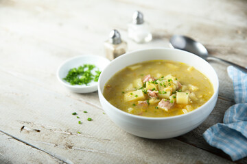 Traditional homemade pea soup with smoked bacon