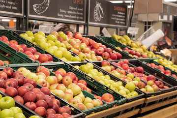 apples in a supermarket on showcases in boxes, fruits in a store