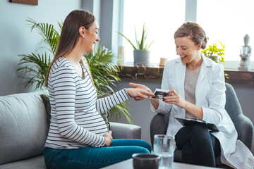 Happy pregnant woman visit gynecologist doctor at hospital or medical clinic for pregnancy consultant. Doctor examine pregnant belly for baby and mother healthcare check up. Gynecology concept.