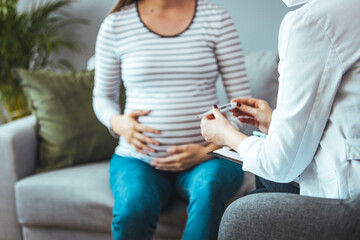 Female doctor visiting her patient at her home for the routine medical exam during coronavirus pandemic lockdown. Measuring the body temperature for excluding COVID-19 pandemic symptoms. 
