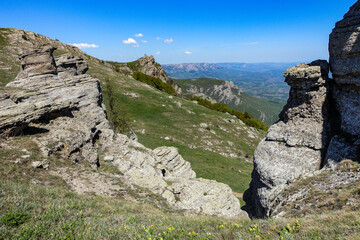 Ancient limestone high mountains of rounded shape in the air haze. The Valley of Ghosts. Demerji. Crimea.