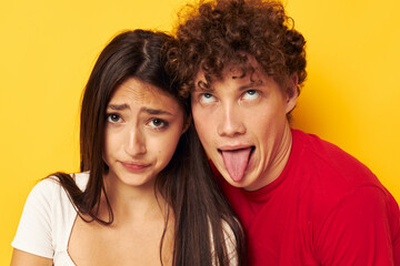 portrait of a man and a woman Friendship posing hugs together yellow background unaltered