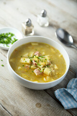 Traditional homemade pea soup with smoked bacon
