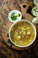 Traditional homemade pea soup with smoked bacon