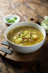 Traditional homemade pea soup with smoked bacon