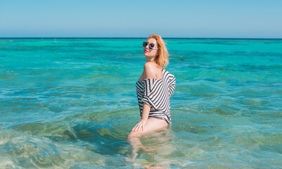 Vacation scene. Panoramic views of blue sea and coastline. Beautiful landscape, aerial view, Egypt. Plus size woman enjoys view of coast of Red Sea. High quality photo