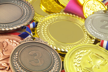 Gold, silver and bronze medals close up. Sport medals background.