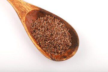 Flax seeds in wooden spoon isolated on white background.