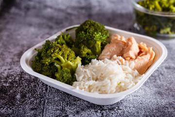 Bowl with salmon, basmati rice and broccoli.