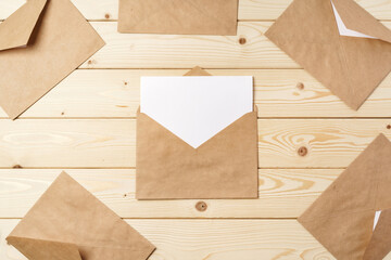 Craft paper envelopes on wooden table, top view