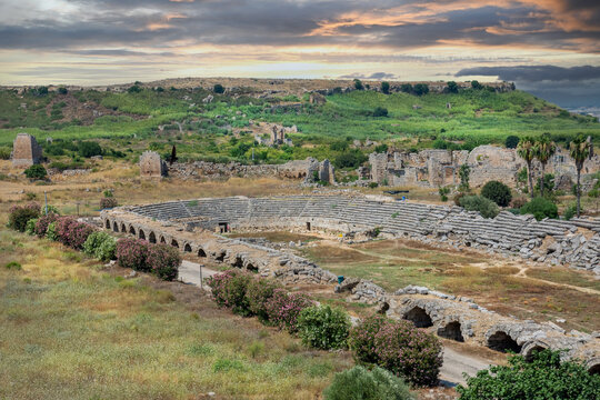 Ancient stadium in Perge. Deconstructed spectator benches. The stadium is U-shaped. Spectator benches made of marble. 70 vaulted arches. Ruins of the stadium in Perge. Remote shot. - Powered by Adobe