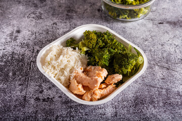 Bowl with salmon, basmati rice and broccoli.