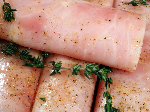 Culinary background. Ham rolled in rolls with spices