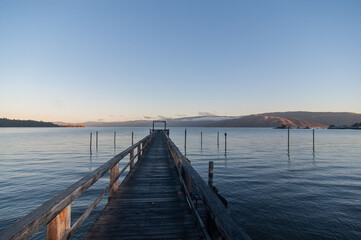 Fototapeta na wymiar Early morning at the lake on the dock in autumn