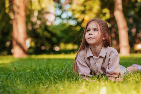 the girl is lying on the green grass	
