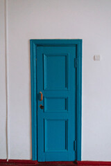 blue door in a white wall