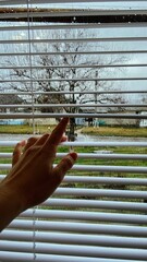 blinds on the window and raindrops