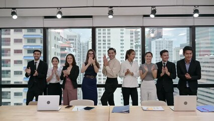 Multi ethnic business group clapping hands of successful after business seminar in modern office