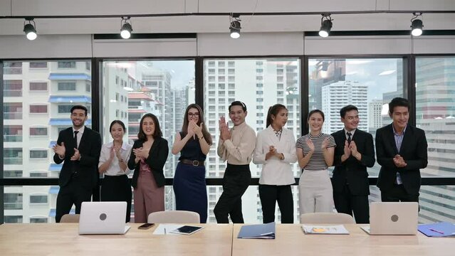 Multi ethnic business group clapping hands of successful after business seminar in modern office