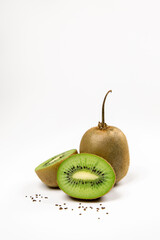 Whole kiwi fruit with stem and his segments on white background with seeds 
