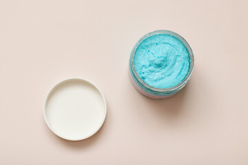 Shower scrub care for women on a plain background close-up. Spa treatments for the body bubble gum. Content filming of products.