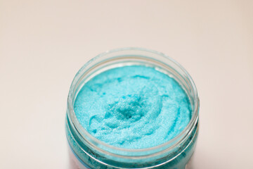 Shower scrub care for women on a plain background close-up. Spa treatments for the body bubble gum. Content filming of products.