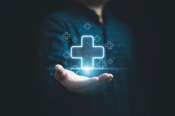 Businessman holding virtual blue plus sign for positive thinking mindset or healthcare insurance symbol concept.
