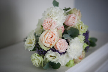 bouquet in light colors with pink roses, white eustoma with the addition of eucalyptus