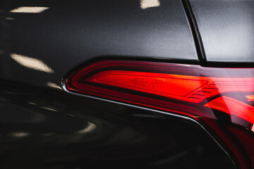 Detail on the rear light of a black car