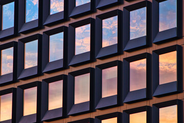 the wall of windows mirroring sky