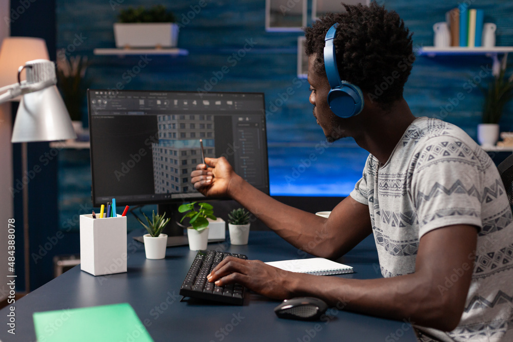 Poster african american technical architect with headphones pointing at building construction on computer w