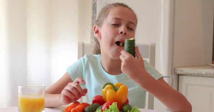 the child eats vegetables with pleasure. The girl eats healthy food. the concept of children's health