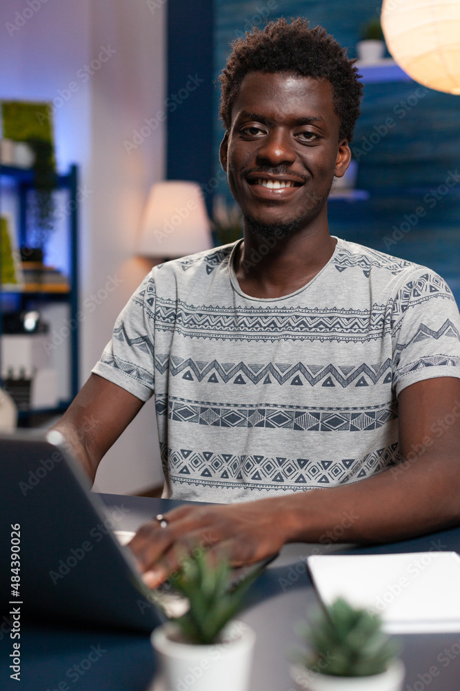 Poster portrait of smiling student working remote from home at business project using laptop computer. youn