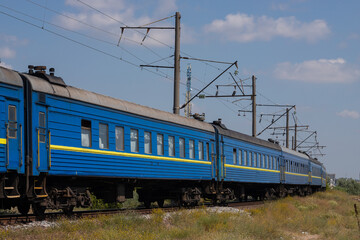 Fototapeta na wymiar Old blue passenger train, carriages on a sunny summer day