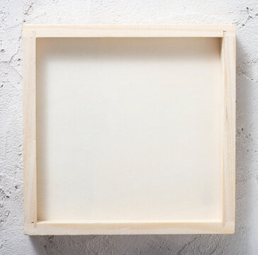 Wooden frame, box on a concrete wall Abstract background