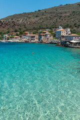 view of  Limeni village with the  turquoise waters and the stone buildings as a background  in Mani, South Peloponnese , Greece.