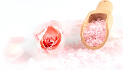 rose salt with rose petals on white background top view.