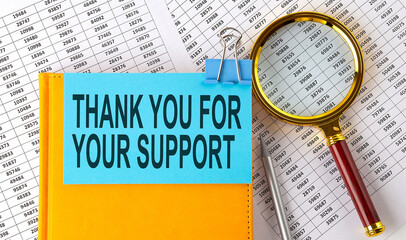 THANK YOU FOR YOUR SUPPORT text on sticker on notebook with magnifier and chart. Business