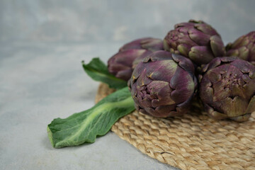 Artichokes isolated on a gray background. Top view. Copy space.