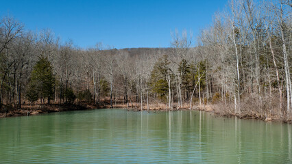 Lake Fort Smith, AR, in winter with bare branches and calm water