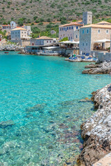 view of  Limeni village with the  turquoise waters and the stone buildings as a background  in Mani, South Peloponnese , Greece.