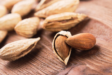 Nuts almonds on a wooden   table closeup