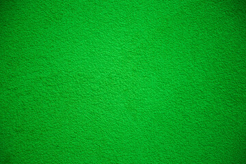 Green defocused background . Natural grass color wall stucco texture.