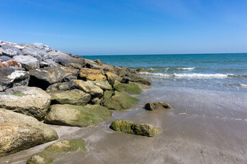 Lots of rocks along the coast to prevent damage from ocean waves.