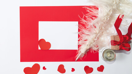 The minimum layout of a letter with envelope on a white background is next to paper hearts....