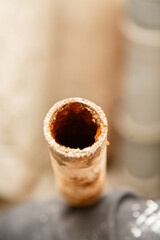 rusty water pipe after thirty years of operation. Corrosion inside a pipe. Water filter. Replacement of water supply. Repair in a bathroom. Old pipes of communications. Need to clean a tap water