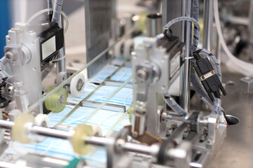 Industry and factory concept, medical face mask production line.