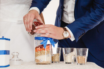Details of wedding ceremony and tradition of making family amulet from different grain, indoor....
